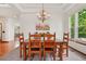 Formal dining room with a dark wooden table and chairs, with natural light at 641 Briar Haven Dr, Castle Pines, CO 80108