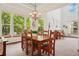 Bright dining room featuring large windows and a wooden dining table at 641 Briar Haven Dr, Castle Pines, CO 80108