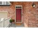 Charming brick home featuring a red front door with a welcoming mat at 641 Briar Haven Dr, Castle Pines, CO 80108