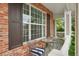 Cozy front porch with comfortable seating and brick columns at 641 Briar Haven Dr, Castle Pines, CO 80108