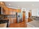 Traditional kitchen with stainless steel appliances, hardwood floors, and wooden cabinetry at 641 Briar Haven Dr, Castle Pines, CO 80108