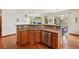 Well-lit kitchen with stainless steel appliances, wooden cabinets, and open access to living areas at 641 Briar Haven Dr, Castle Pines, CO 80108