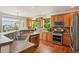 Bright kitchen featuring stainless steel appliances, wood cabinets, and hardwood flooring at 641 Briar Haven Dr, Castle Pines, CO 80108