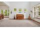 Bright living room with carpet and lots of windows, decorated with musical instruments and wall art at 641 Briar Haven Dr, Castle Pines, CO 80108