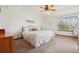 Cozy main bedroom with decorative wall art, a ceiling fan, and a large window for natural light at 641 Briar Haven Dr, Castle Pines, CO 80108