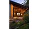 Inviting backyard patio with string lights, comfortable seating, lush landscaping, and a charming stream at 2060 Hoyt St, Lakewood, CO 80215