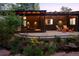 Home's backyard features a covered outdoor living space, beautiful landscaping, a water feature, and inviting patio furniture at 2060 Hoyt St, Lakewood, CO 80215