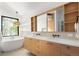 Bright bathroom with double vanity, modern fixtures, and soaking tub at 2060 Hoyt St, Lakewood, CO 80215