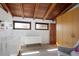 Well-lit bedroom featuring wood accents, a crib, and a comfortable sitting area at 2060 Hoyt St, Lakewood, CO 80215