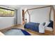 Charming bedroom with a stylish rug, built-in storage, and natural light at 2060 Hoyt St, Lakewood, CO 80215