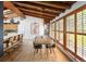 Dining area featuring wood floors, exposed beams and natural light from large windows at 2060 Hoyt St, Lakewood, CO 80215