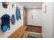 Inviting entryway with a bench, wooden door, and modern storage at 2060 Hoyt St, Lakewood, CO 80215