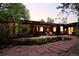 Exterior view of a home featuring a modern design, landscaped yard, and a stone pathway to the front entrance at 2060 Hoyt St, Lakewood, CO 80215