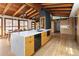 Bright kitchen featuring an island, quartz countertops, wood cabinets, and exposed wood beams at 2060 Hoyt St, Lakewood, CO 80215