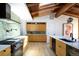 Bright, modern kitchen featuring a large island, skylights, and stainless steel appliances at 2060 Hoyt St, Lakewood, CO 80215