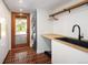 Functional laundry room featuring a utility sink, stacked washer/dryer, and wood countertop at 2060 Hoyt St, Lakewood, CO 80215