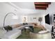 Spacious living room with large sectional, modern decor, and wood beamed ceilings at 2060 Hoyt St, Lakewood, CO 80215