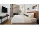Stylish bedroom with accent wall, fireplace, and plush king bed at 2060 Hoyt St, Lakewood, CO 80215