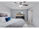 Bright bedroom featuring a large bed with stylish bedding, a window, and an en-suite bathroom at 11338 Donley Dr, Parker, CO 80138