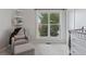 Bedroom area with comfy chair and ottoman, a view of nature, and new carpet at 11338 Donley Dr, Parker, CO 80138