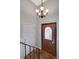Welcoming entryway featuring hardwood floors, a stylish light fixture, and convenient access to the rest of the home at 11338 Donley Dr, Parker, CO 80138
