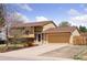 Charming two-story home featuring a well-maintained front yard and an attached two-car garage at 11338 Donley Dr, Parker, CO 80138