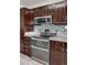 Modern kitchen with stainless steel appliances, granite countertops, and ample cabinet space at 11338 Donley Dr, Parker, CO 80138
