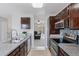 Modern kitchen featuring stainless steel appliances, tile backsplash and a view to the living room at 11338 Donley Dr, Parker, CO 80138