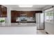 Modern kitchen features stainless steel appliances, granite countertops, and ample cabinet space at 11338 Donley Dr, Parker, CO 80138