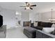 Open-concept living room featuring a large sectional, ceiling fan and access to the kitchen at 11338 Donley Dr, Parker, CO 80138
