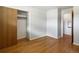 Bedroom boasts wood floors, closet and access to other rooms at 7475 W Vassar Ave, Lakewood, CO 80227