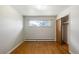 Cozy bedroom features wood floors, closet space, and a bright window at 7475 W Vassar Ave, Lakewood, CO 80227