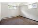 Standard bedroom with cozy carpet, white walls, and natural lighting from dual windows at 7475 W Vassar Ave, Lakewood, CO 80227