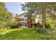 Two-story red brick home with a well-maintained lawn and established trees at 7475 W Vassar Ave, Lakewood, CO 80227