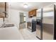 Basement kitchen features stainless steel appliances at 7475 W Vassar Ave, Lakewood, CO 80227
