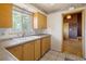 Functional kitchen with wood cabinets and an undermount stainless steel sink at 7475 W Vassar Ave, Lakewood, CO 80227