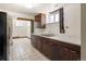 Basement kitchen features wooden cabinetry and appliances at 7475 W Vassar Ave, Lakewood, CO 80227