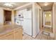 Traditional kitchen features white appliances, an island, and patterned tile flooring at 7475 W Vassar Ave, Lakewood, CO 80227