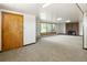 Large living room with ample natural light from the windows and a brick fireplace at 7475 W Vassar Ave, Lakewood, CO 80227