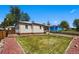 Backyard features a manicured lawn and garden beds, offering a great outdoor space at 8881 Lilly Dr, Thornton, CO 80229