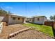 Spacious backyard with a patio area, garden beds, green grass and partial fence, perfect for outdoor activities at 8881 Lilly Dr, Thornton, CO 80229
