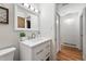 Clean bathroom with white vanity, modern fixtures, and hardwood floors at 8881 Lilly Dr, Thornton, CO 80229