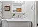 Bright bathroom featuring a modern sink, white vanity, and contemporary design at 8881 Lilly Dr, Thornton, CO 80229