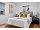 Tranquil bedroom with comfortable bedding, natural light, and hardwood floors at 8881 Lilly Dr, Thornton, CO 80229
