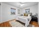 Serene bedroom with a comfortable queen-sized bed, hardwood floors, and natural light at 8881 Lilly Dr, Thornton, CO 80229