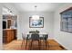 Cozy dining room featuring a modern light fixture, stylish decor, and hardwood floors at 8881 Lilly Dr, Thornton, CO 80229
