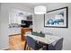 Cozy dining room adjacent to the kitchen featuring a modern light fixture and stylish decor at 8881 Lilly Dr, Thornton, CO 80229