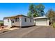 Side view of the home including detached garage at 8881 Lilly Dr, Thornton, CO 80229