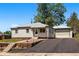 Charming home with a well-maintained front yard and attached garage, perfect for easy parking at 8881 Lilly Dr, Thornton, CO 80229