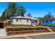 Charming single-story home with manicured front yard and landscaped garden beds at 8881 Lilly Dr, Thornton, CO 80229